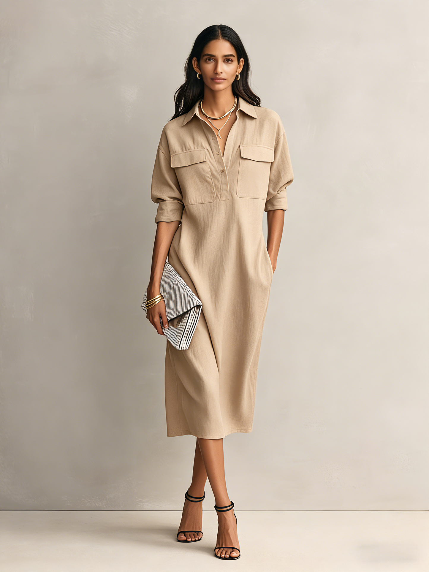 Apricot - Model wearing a relaxed fit collared midi shirtdress with chest pockets and rolled sleeves, styled with gold jewelry and strappy heels
