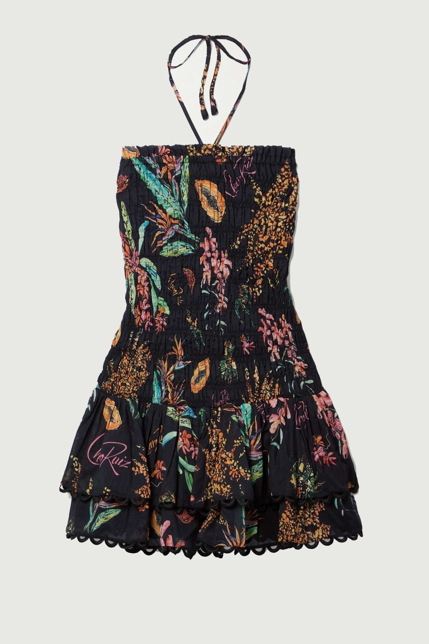 Woman wearing black strapless mini dress with tropical print