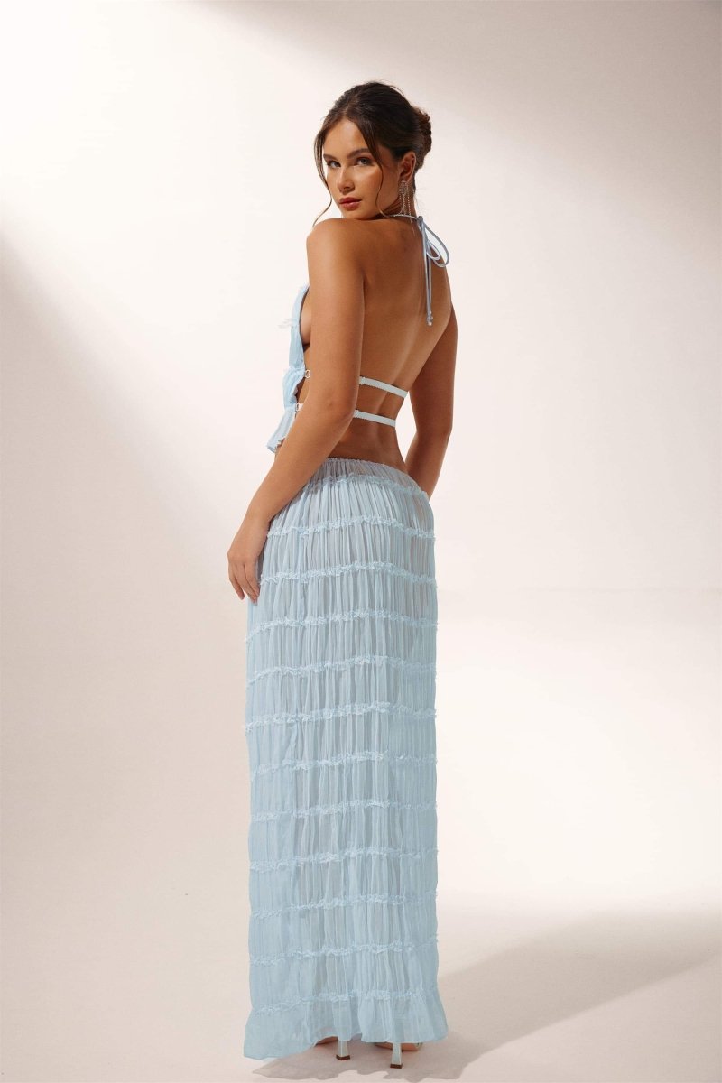 Woman in light blue crinkle gauze halter top and maxi skirt