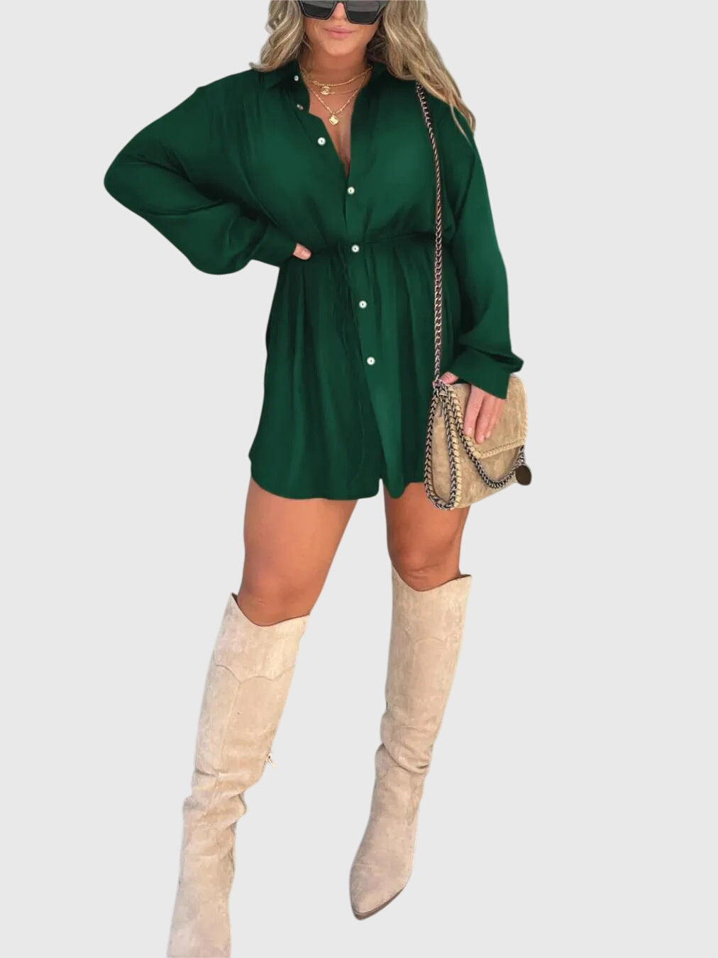 Green - A woman wearing a long-sleeve burgundy satin romper with a button-down front, pointed collar, and cinched waist, styled with knee-high beige boots.