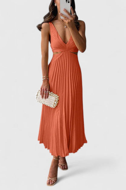 Orange - A woman wearing a pale yellow pleated satin midi dress with a plunging V-neckline and side waist cutouts, holding a pearl-embellished clutch.