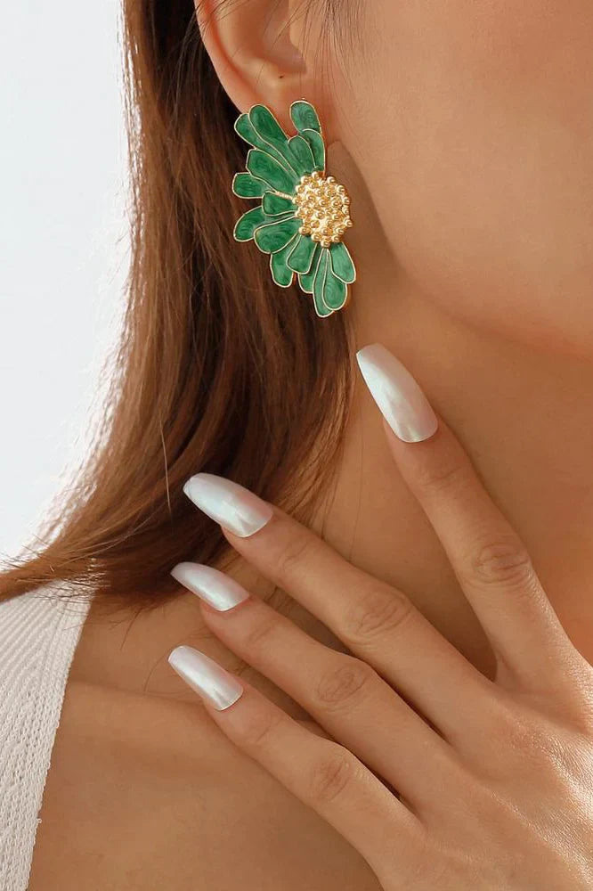 Close up of green enamel flower earring with gold plated center