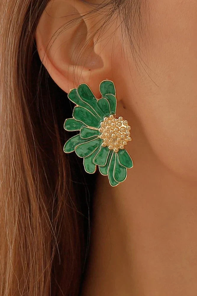Close up of green enamel flower earring with gold plated center