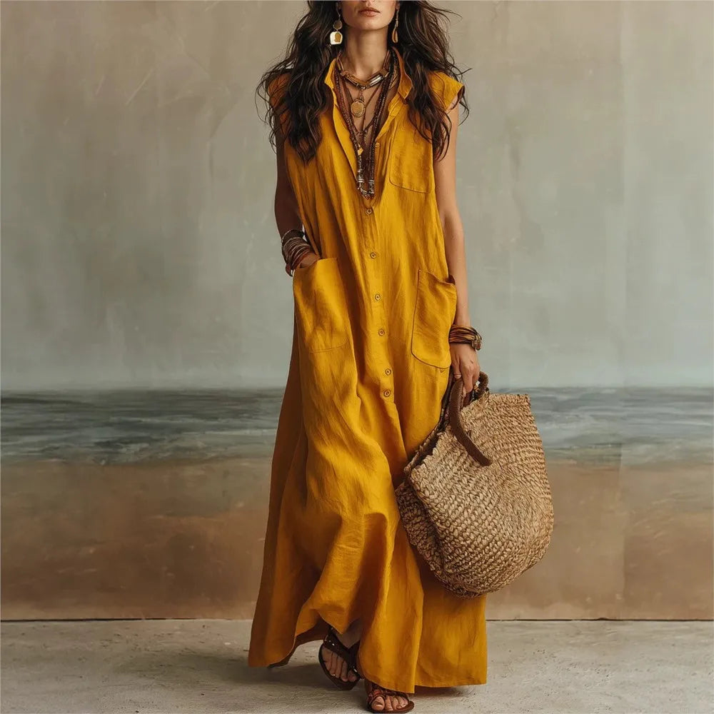 Yellow - Woman wearing a long, sleeveless linen maxi dress with a collar, button-down front, and large patch pockets, holding a woven tote bag.