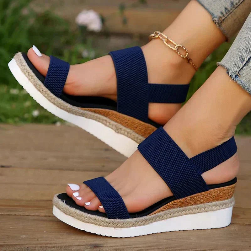 Blue - Women's open-toe platform sandals featuring wide stretch-fabric straps, a cushioned footbed, and a layered sole with jute-trim detailing.