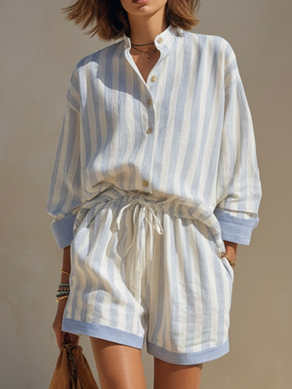 White - Woman walking outdoors wearing a relaxed fit, striped long-sleeve button-down shirt and matching drawstring shorts set.