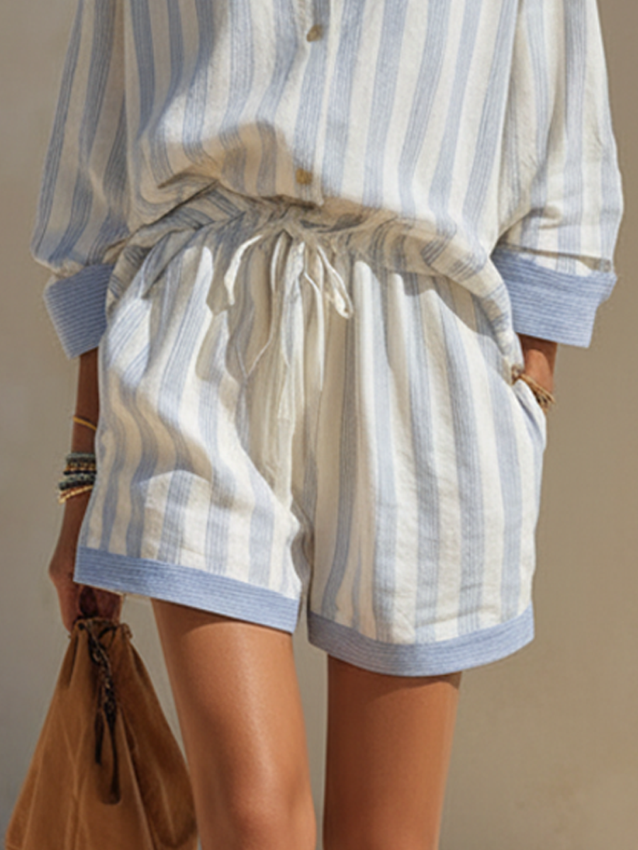 White - Woman walking outdoors wearing a relaxed fit, striped long-sleeve button-down shirt and matching drawstring shorts set.