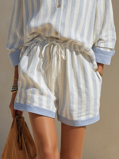 White - Woman walking outdoors wearing a relaxed fit, striped long-sleeve button-down shirt and matching drawstring shorts set.