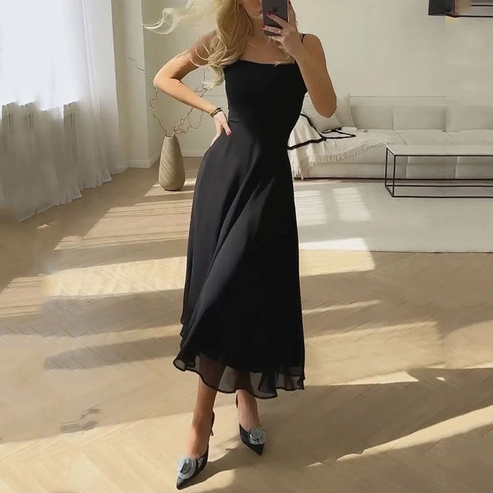 Black - A woman wearing a solid white midi dress with a structured square-neck corset bodice and a flowy chiffon A-line skirt, paired with silver heeled sandals.