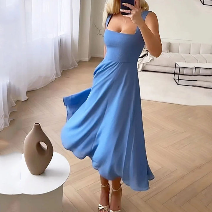 Blue - A woman wearing a solid white midi dress with a structured square-neck corset bodice and a flowy chiffon A-line skirt, paired with silver heeled sandals.