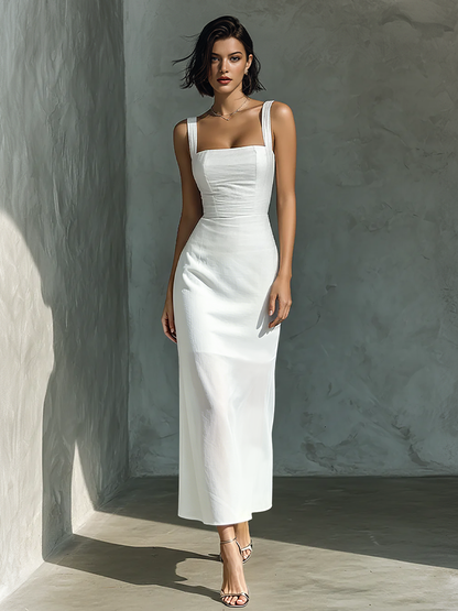 Model wearing a solid square-neck sleeveless maxi dress with a fitted bodice and straight skirt, standing against a textured grey wall.
