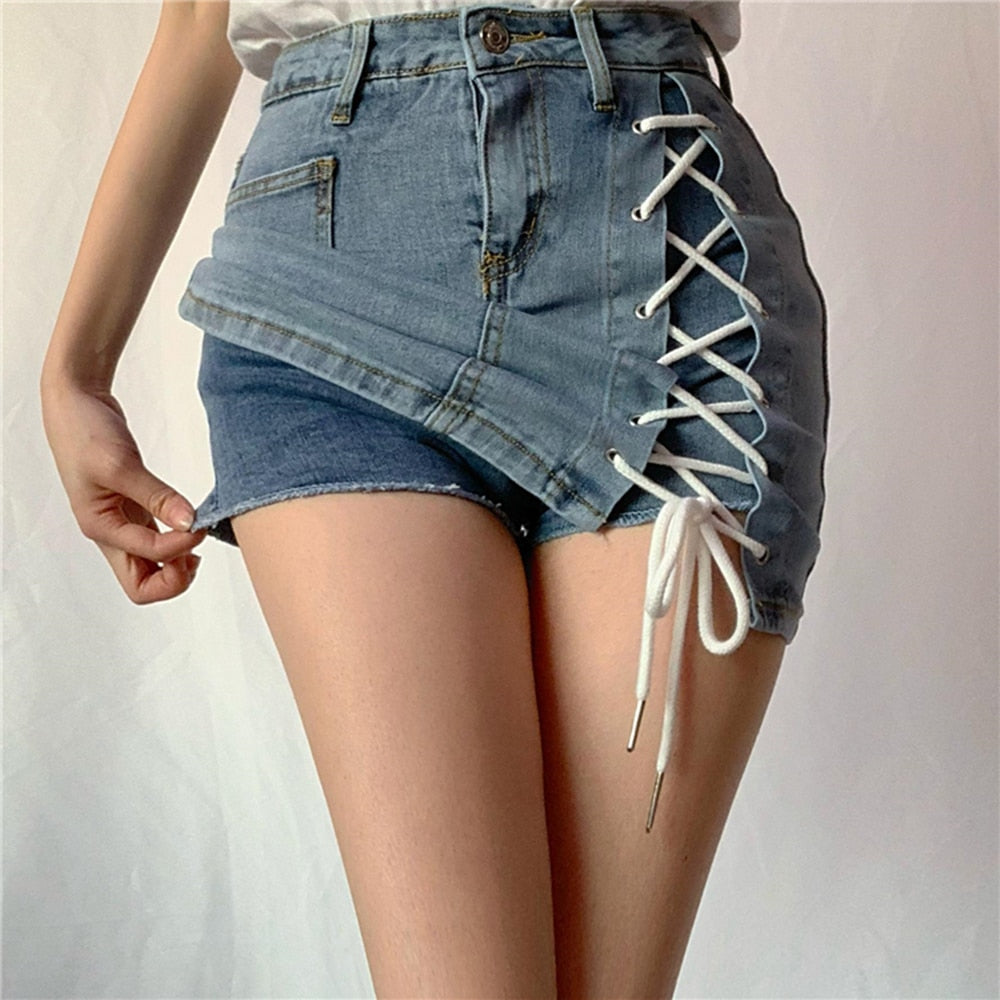 Woman wearing a light blue denim mini skirt with white lace-up side detail.
