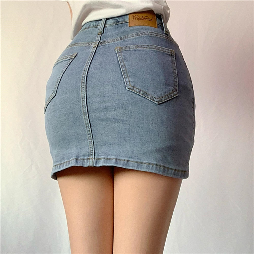 Woman wearing a light blue denim mini skirt with white lace-up side detail.