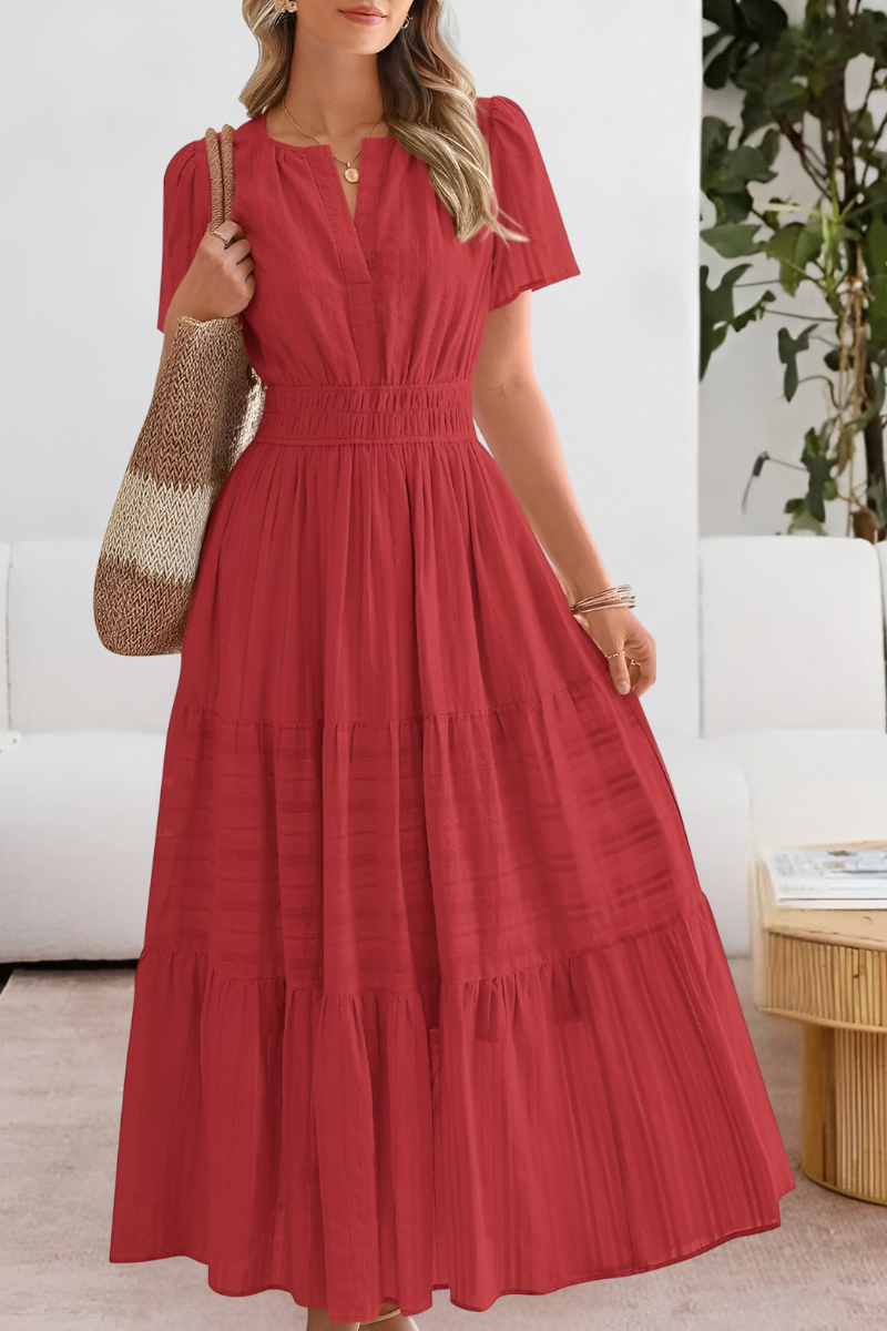 Red - A woman wearing a yellow textured cotton midi sundress with a smocked waist, split V-neckline, flutter sleeves, and a tiered skirt, holding a woven tote bag.