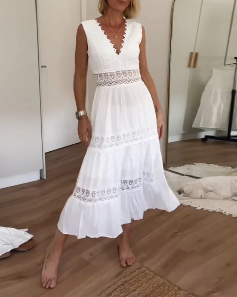 Woman wearing a sleeveless V-neck tiered maxi sundress featuring intricate crochet waist paneling and trim details.