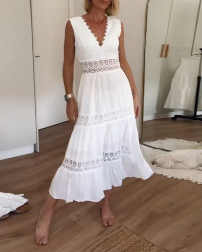 Woman wearing a sleeveless V-neck tiered maxi sundress featuring intricate crochet waist paneling and trim details.