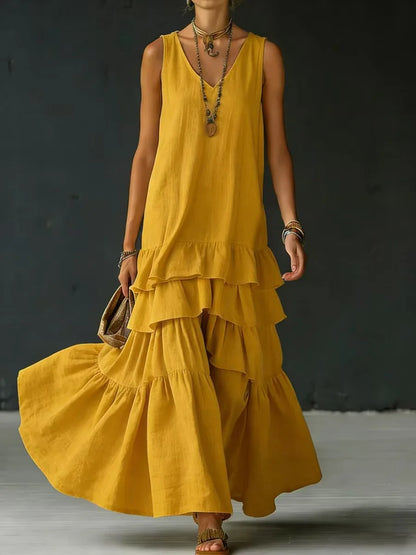 Yellow - Woman wearing a sleeveless, v-neck, tiered ruffle maxi sundress in a textured fabric.