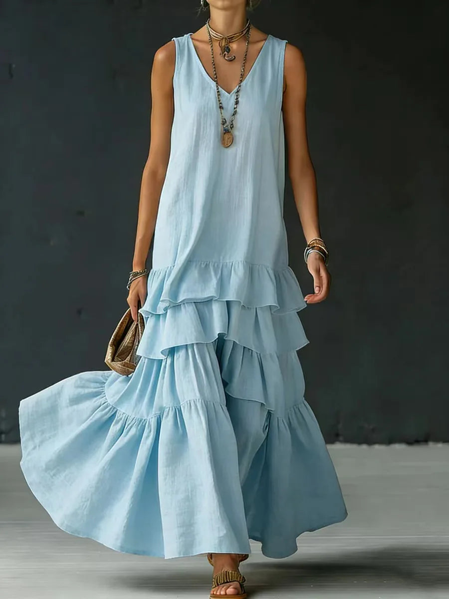 Light Blue - Woman wearing a sleeveless, v-neck, tiered ruffle maxi sundress in a textured fabric.