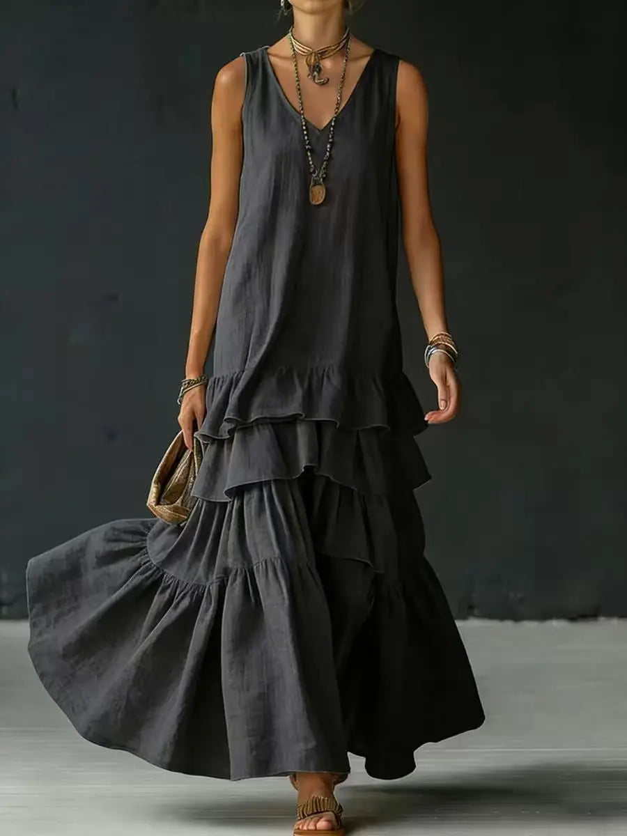 Black - Woman wearing a sleeveless, v-neck, tiered ruffle maxi sundress in a textured fabric.