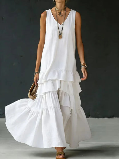 White - Woman wearing a sleeveless, v-neck, tiered ruffle maxi sundress in a textured fabric.