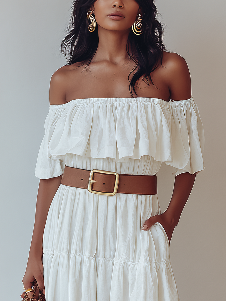 White - Woman wearing an off-the-shoulder tiered maxi dress with a ruffle neckline, styled with a wide belt and woven accessories.