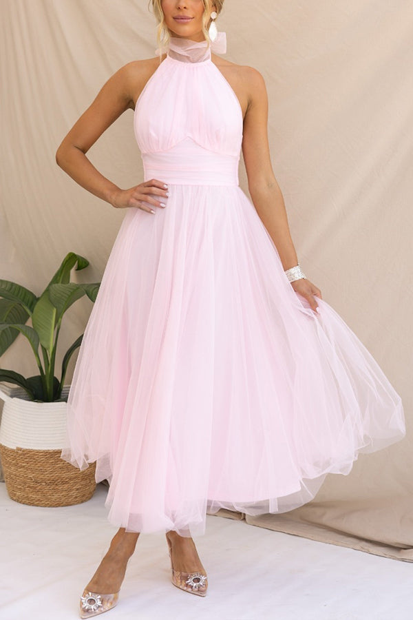 Pink - Woman wearing a sleeveless tulle midi dress with a sheer halter neckline and structured corset bodice