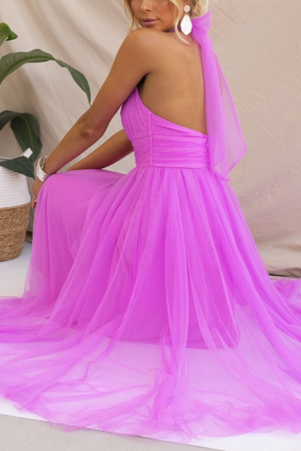 Fuschia - Woman wearing a sleeveless tulle midi dress with a sheer halter neckline and structured corset bodice