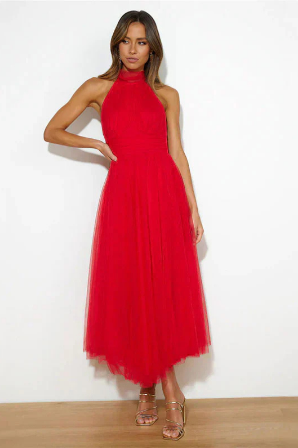 Red - Woman wearing a sleeveless tulle midi dress with a sheer halter neckline and structured corset bodice