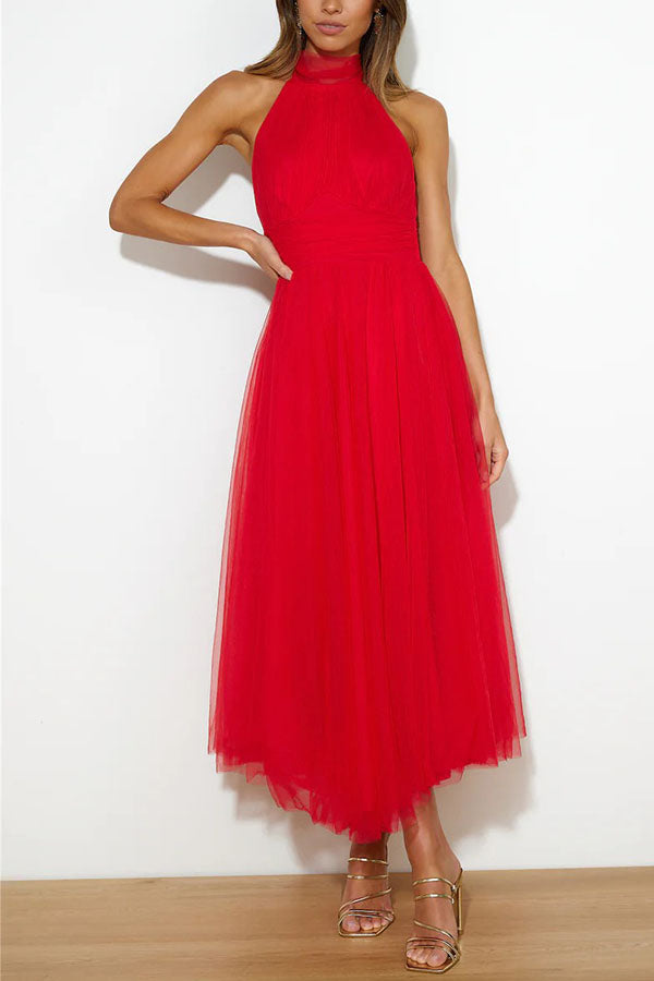Red - Woman wearing a sleeveless tulle midi dress with a sheer halter neckline and structured corset bodice