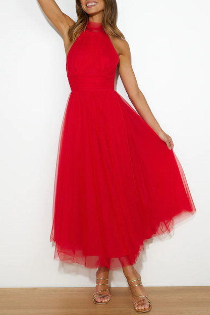 Red - Woman wearing a sleeveless tulle midi dress with a sheer halter neckline and structured corset bodice