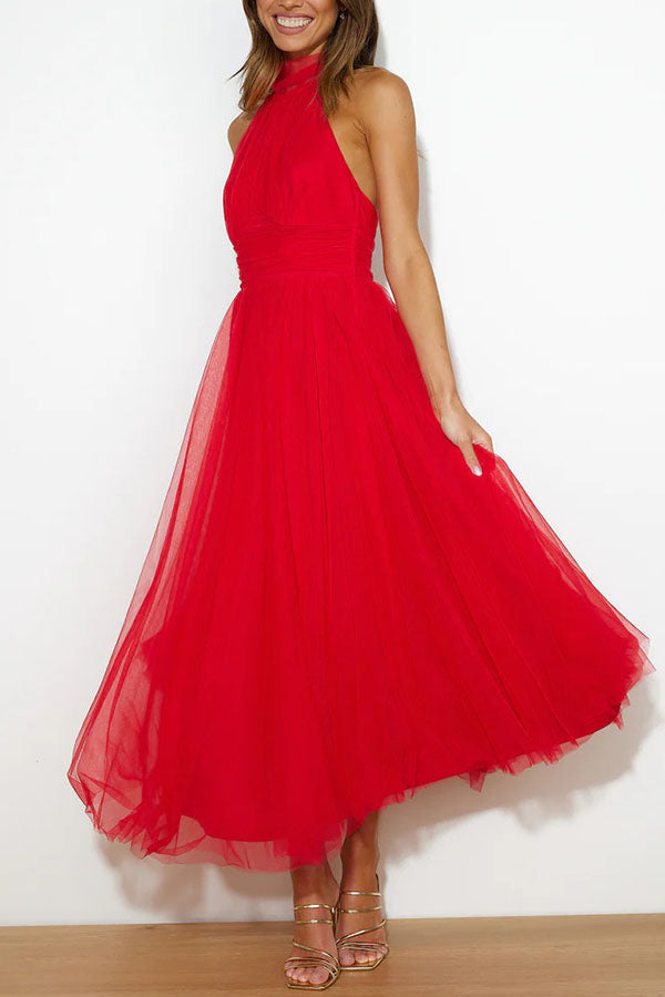 Red - Woman wearing a sleeveless tulle midi dress with a sheer halter neckline and structured corset bodice