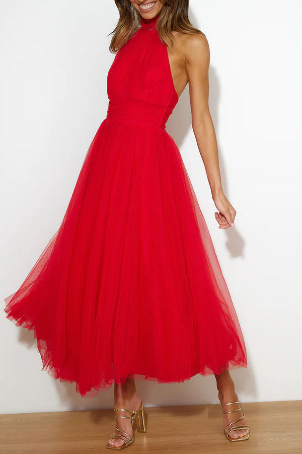 Red - Woman wearing a sleeveless tulle midi dress with a sheer halter neckline and structured corset bodice