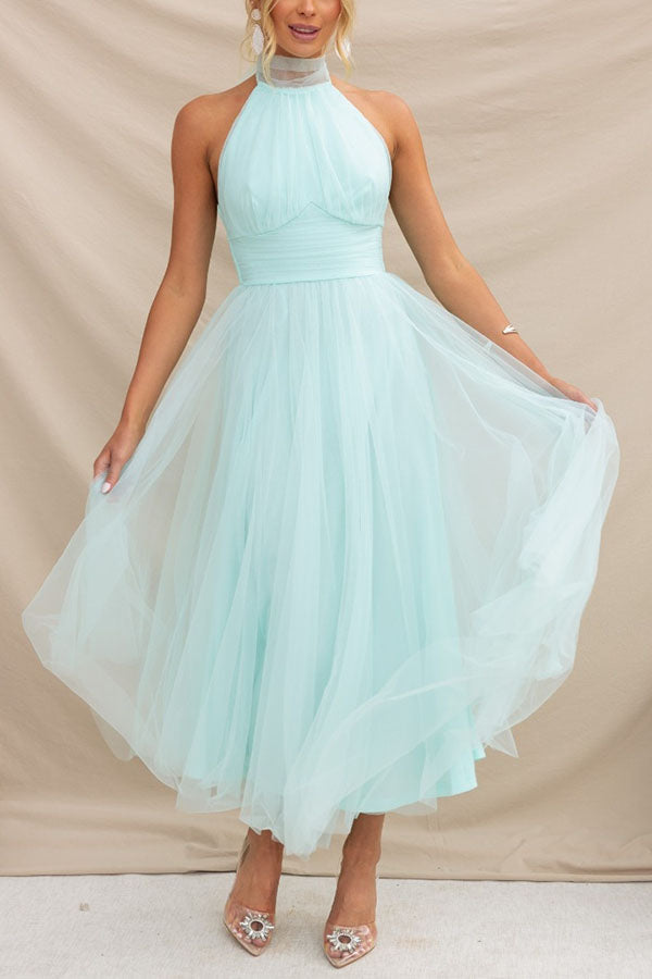 Light Blue - Woman wearing a sleeveless tulle midi dress with a sheer halter neckline and structured corset bodice