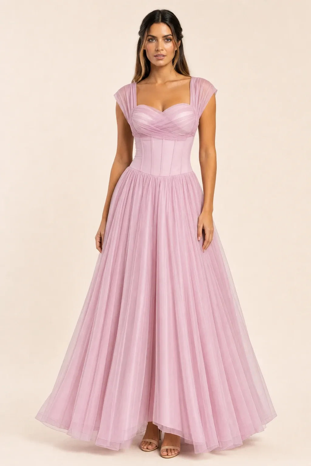 Pink - Model wearing a romantic midi dress featuring a ruched sweetheart neckline, sheer cap sleeves, structured corset bodice with visible boning, and a full layered tulle skirt, standing indoors near a sunlit window.