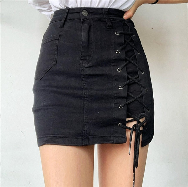 Woman wearing a light blue denim mini skirt with white lace-up side detail.