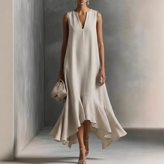 Hemp - Woman wearing a sleeveless V-neck maxi dress with an asymmetrical ruffle hem.