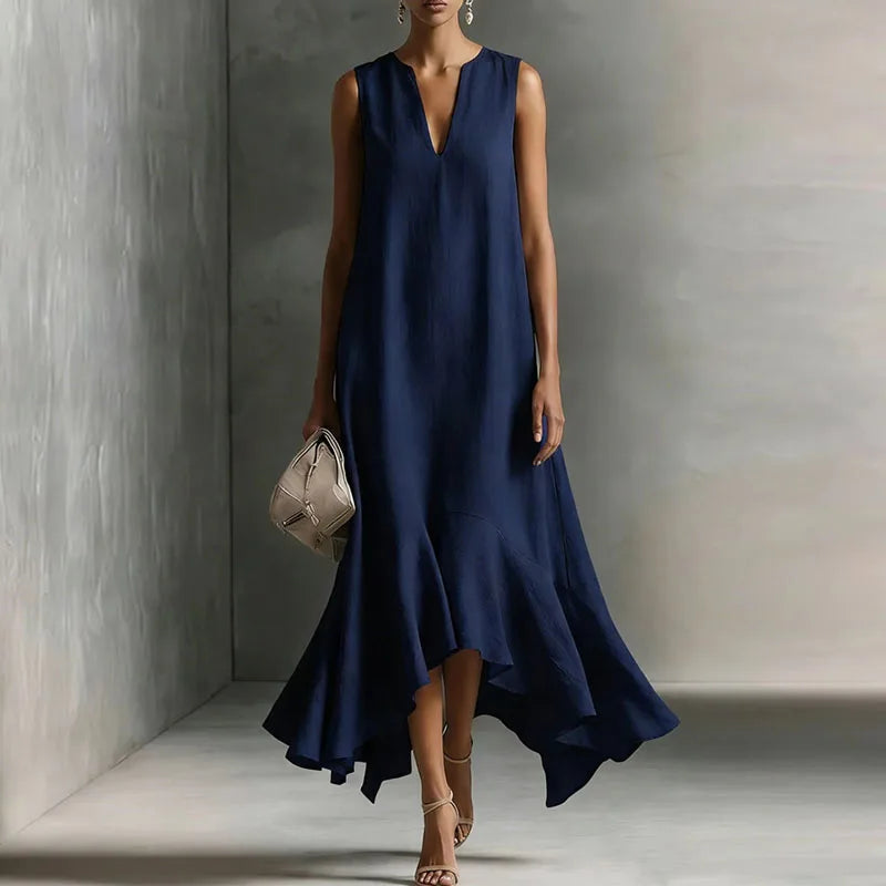 Dark Blue - Woman wearing a sleeveless V-neck maxi dress with an asymmetrical ruffle hem.