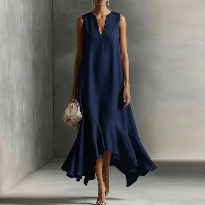 Dark Blue - Woman wearing a sleeveless V-neck maxi dress with an asymmetrical ruffle hem.