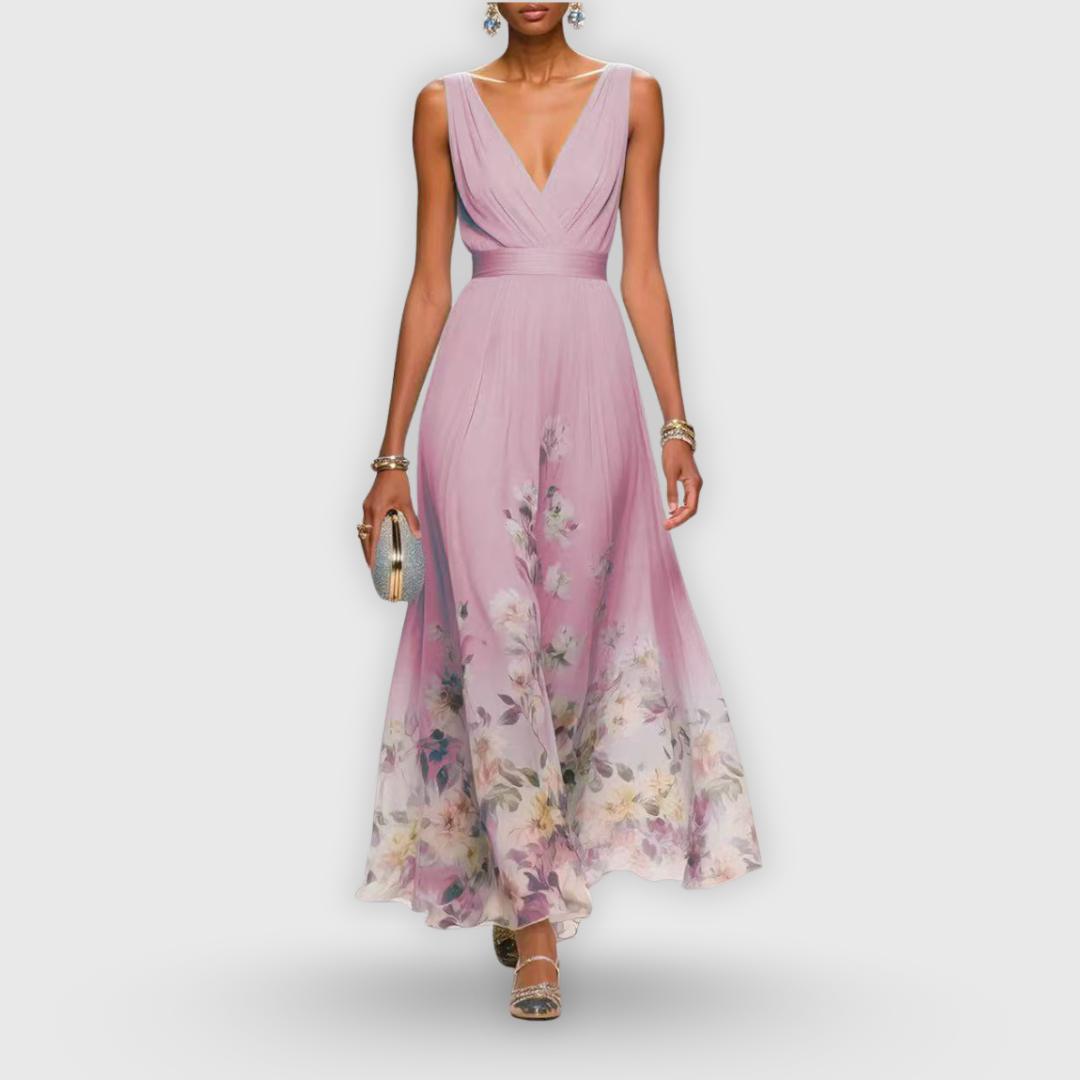 Pink - A woman wearing a sleeveless light blue chiffon maxi dress with a deep V-neck, pleated bodice, and a watercolor floral print along the sweeping hemline.