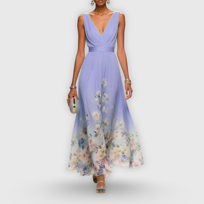 Purple - A woman wearing a sleeveless light blue chiffon maxi dress with a deep V-neck, pleated bodice, and a watercolor floral print along the sweeping hemline.