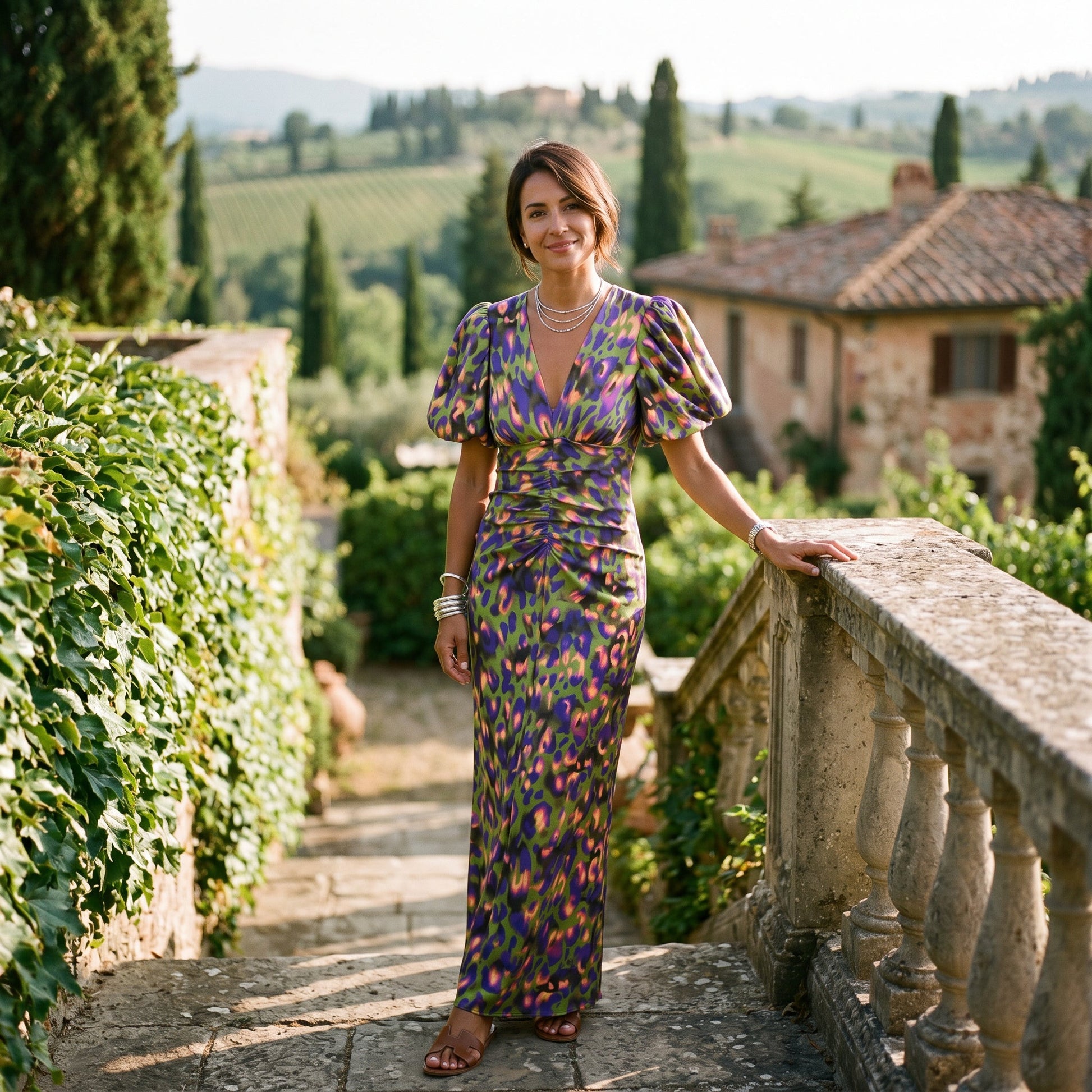 Orange - Model wearing a woven abstract pattern midi dress featuring short puff sleeves, a deep V-neckline, and a heavily ruched center bodice against a white background.