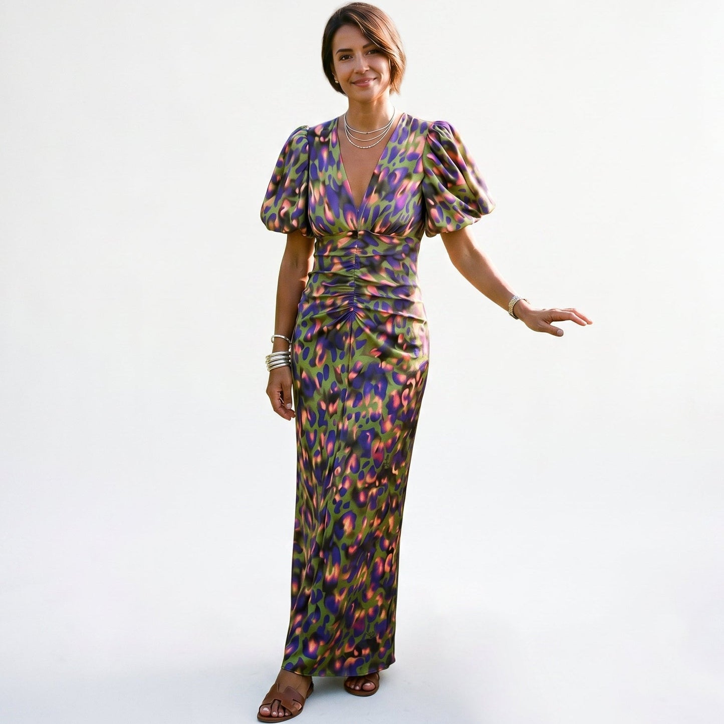 Green - Model wearing a woven abstract pattern midi dress featuring short puff sleeves, a deep V-neckline, and a heavily ruched center bodice against a white background.