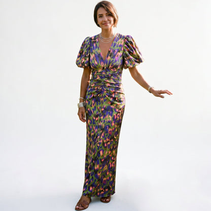 Green - Model wearing a woven abstract pattern midi dress featuring short puff sleeves, a deep V-neckline, and a heavily ruched center bodice against a white background.