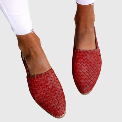 Red - Women's flat slip-on mules featuring a woven faux-leather upper and closed almond toe design.
