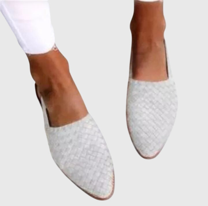 White - Women's flat slip-on mules featuring a woven faux-leather upper and closed almond toe design.