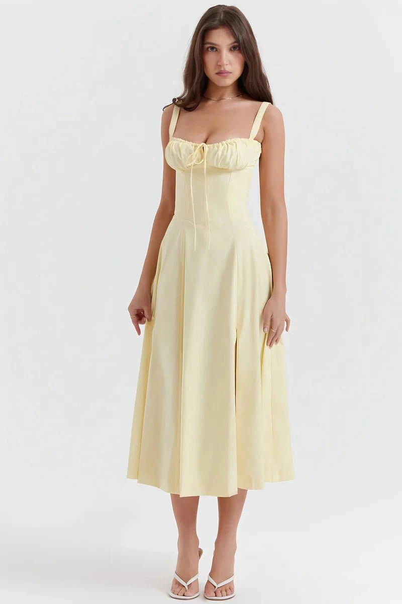 Yellow Linsay - Woman wearing a floral sweetheart midi dress with wide straps, a fitted bodice, and a flowing A-line skirt with a front slit.
