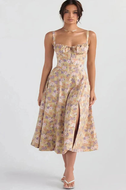 White Rose Linsay - Woman wearing a floral sweetheart midi dress with wide straps, a fitted bodice, and a flowing A-line skirt with a front slit.