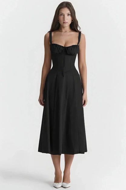 Black Linsay - Woman wearing a floral sweetheart midi dress with wide straps, a fitted bodice, and a flowing A-line skirt with a front slit.