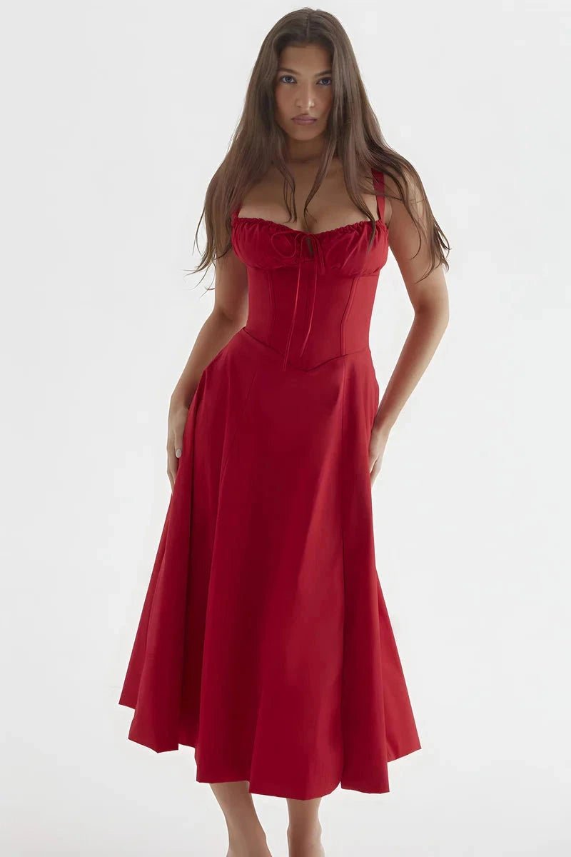 Red Linsay - Woman wearing a floral sweetheart midi dress with wide straps, a fitted bodice, and a flowing A-line skirt with a front slit.
