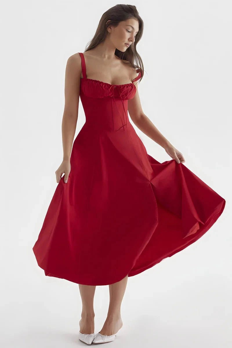 Red Linsay - Woman wearing a floral sweetheart midi dress with wide straps, a fitted bodice, and a flowing A-line skirt with a front slit.